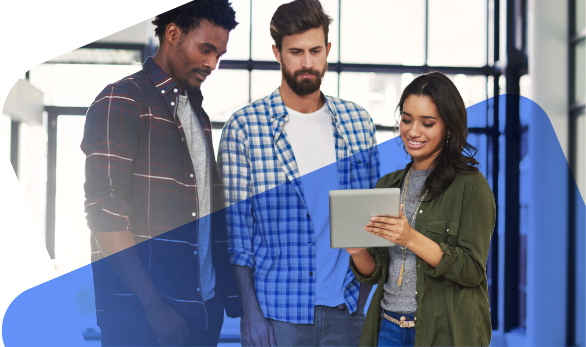 Three people standing and collaborating on tablet